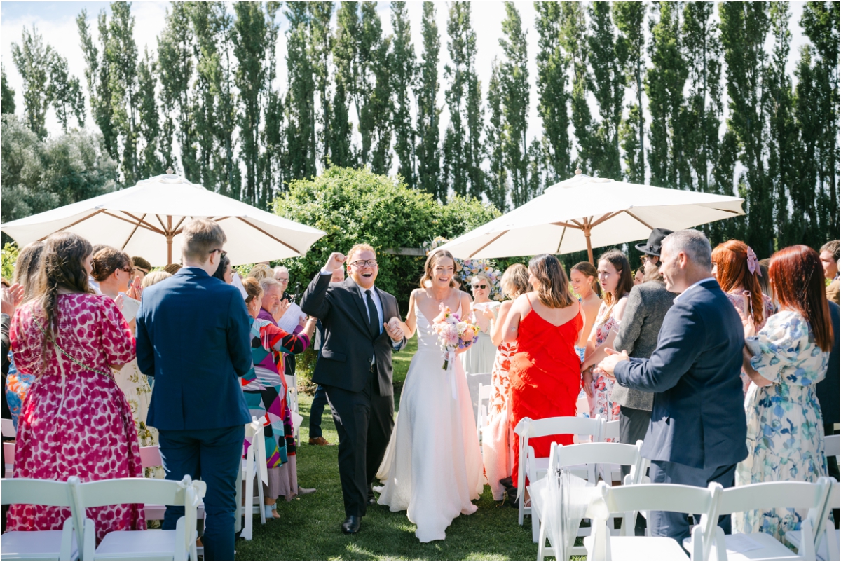 Bride and groom walking down aisle. Wedding venue, Cossars Wineshed, Christchurch