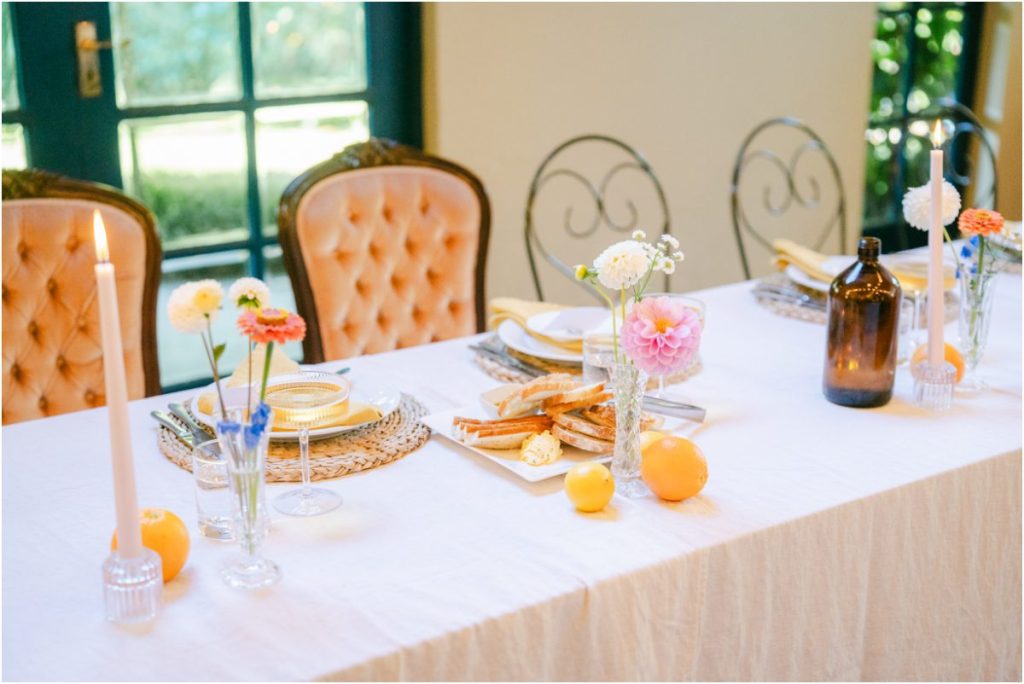 High-end wedding head table styling featuring velvet chairs and floral arrangements by The Little Hire Company at Cossars Wineshed.