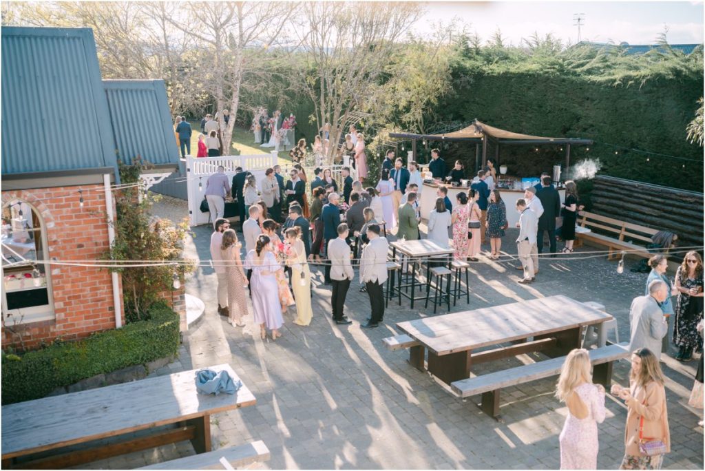 South Canterbury wedding venue: High-angle wide shot of wedding guests mingling in the courtyard at Kingsdown Manor.