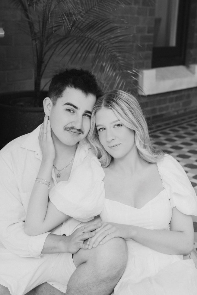Black and white engagement photography: Timeless couple portrait leaning together during a Christchurch session.