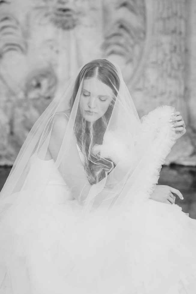 Black and white bridal portrait: Dreamy soft-focus shot of a bride with her wedding veil by Agnes Grace Photo & Film.