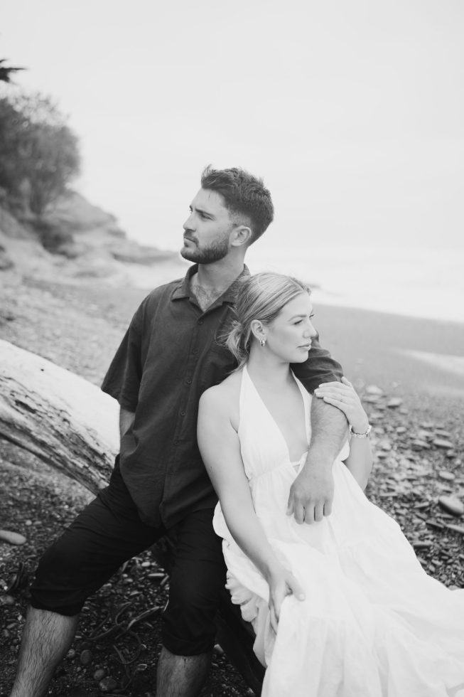 Fine art wedding portrait: Black and white shot of a couple posing on a scenic coastal beach in South Canterbury..