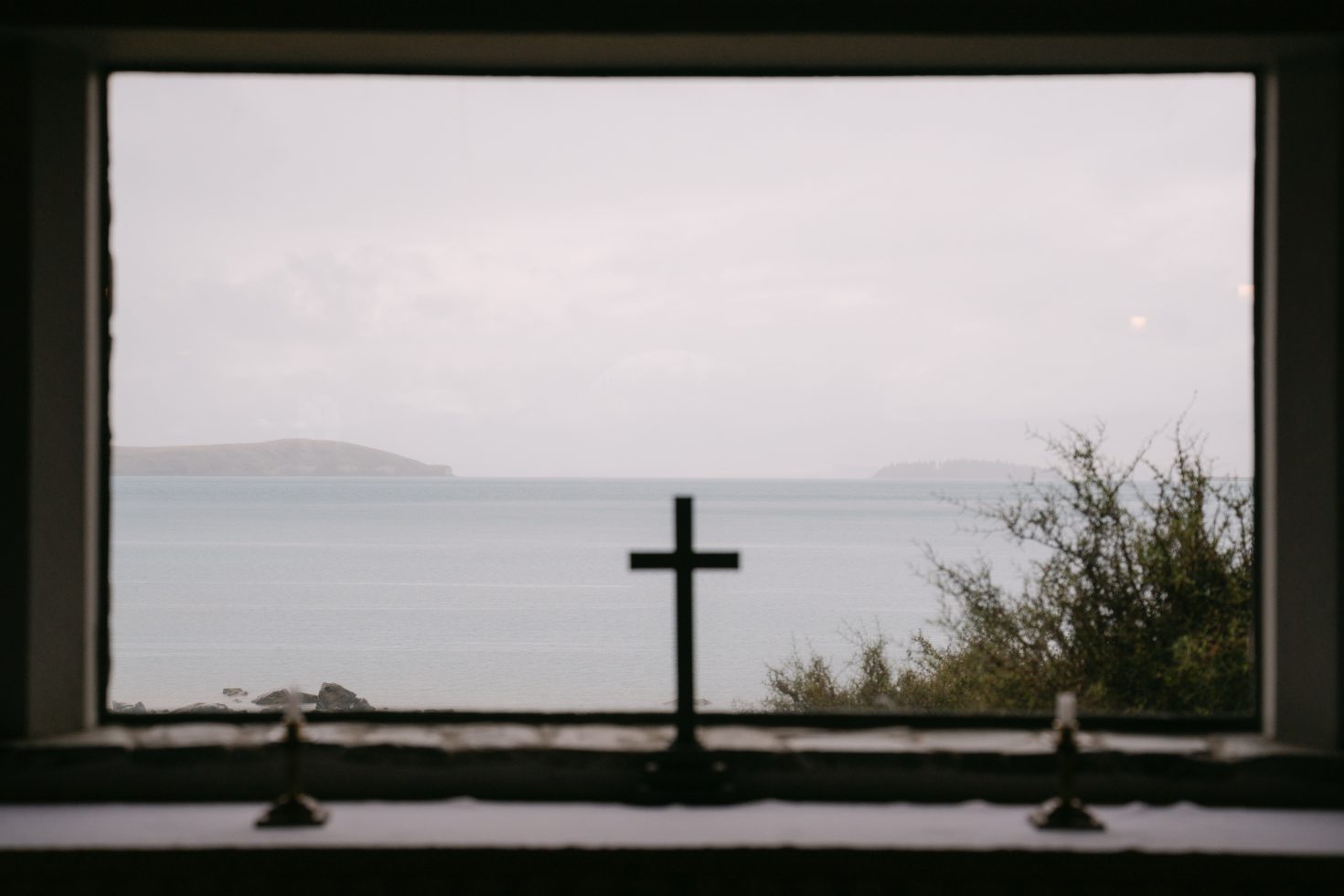 A wide landscape view of the glacial blue water and mountains for a destination wedding in Tekapo.
