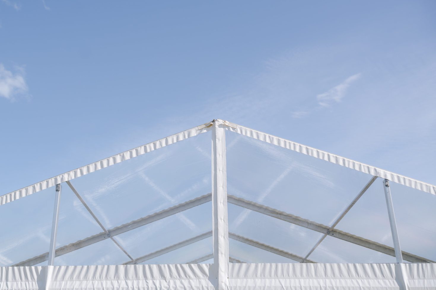 Minimalist clean lines of a high end clear span marquee frame against the sky