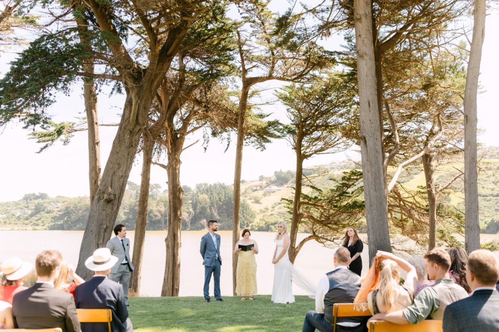 Outdoor ceremony seating layout underneath tall forest pine trees