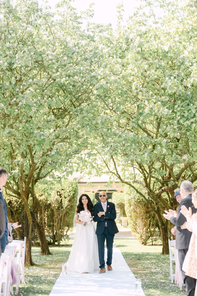 Bride walking down aisle with father